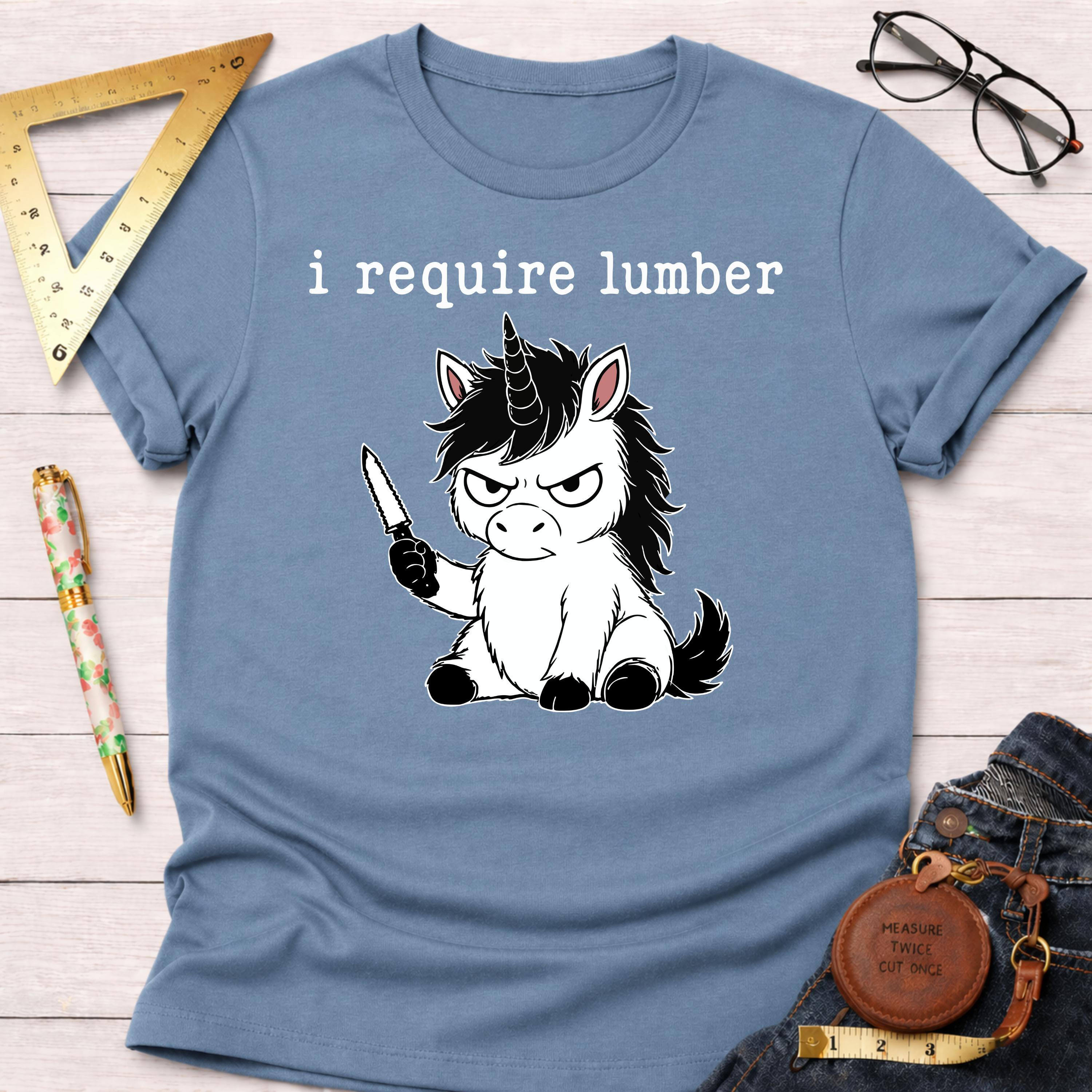 Light blue t-shirt with an angry unicorn holding a knife and "i require lumber" text.