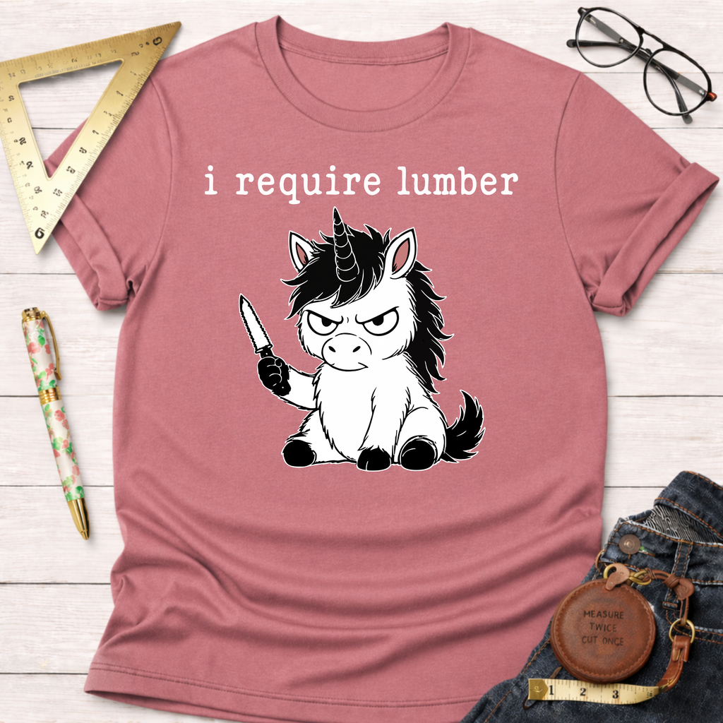 Dusty rose t-shirt with an angry black and white unicorn holding a knife and "i require lumber" text.