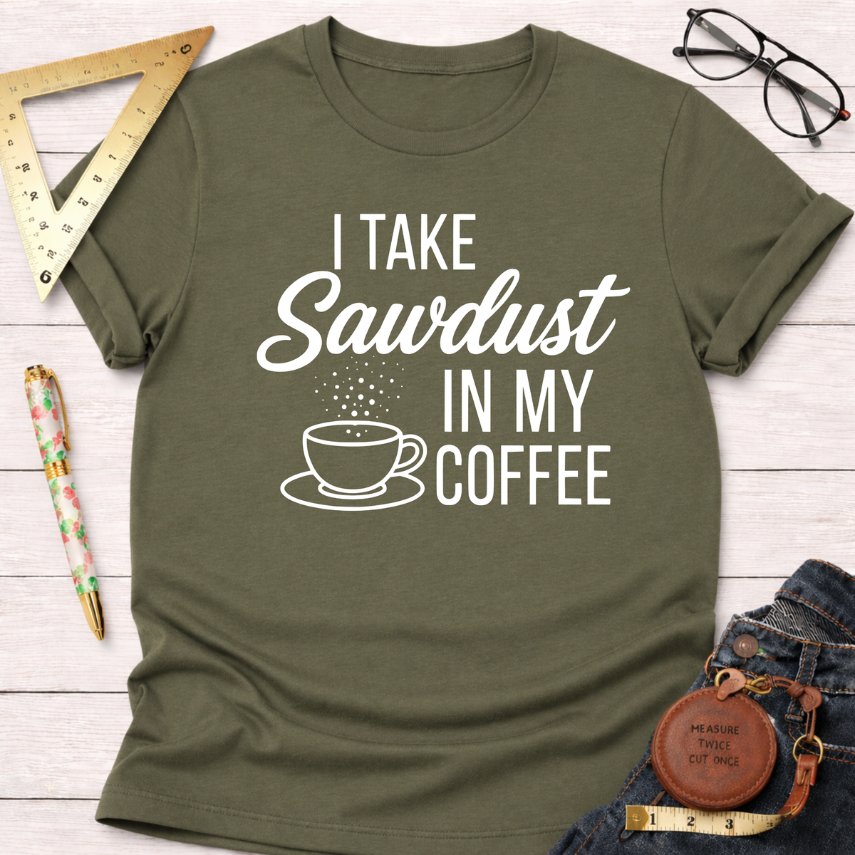 Women's funny woodworking graphic tee shirt for female woodworkers, makers, and DIY builders — Sawdust & Ponytails. Olive green cotton tee with "I Take Sawdust In My Coffee" graphic.