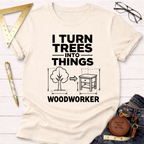 Cream cotton t-shirt with "I Turn Trees Into Things WOODWORKER" graphic, showing a tree turning into a nightstand.