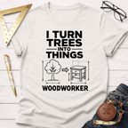 White "I Turn Trees Into Things" graphic t-shirt with a tree transforming into a table design.
