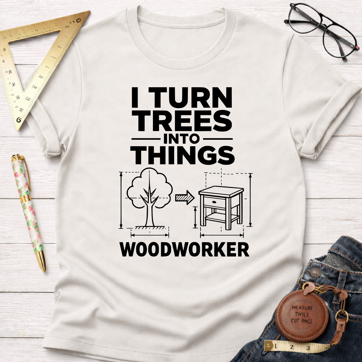 White "I Turn Trees Into Things" graphic t-shirt with a tree transforming into a table design.