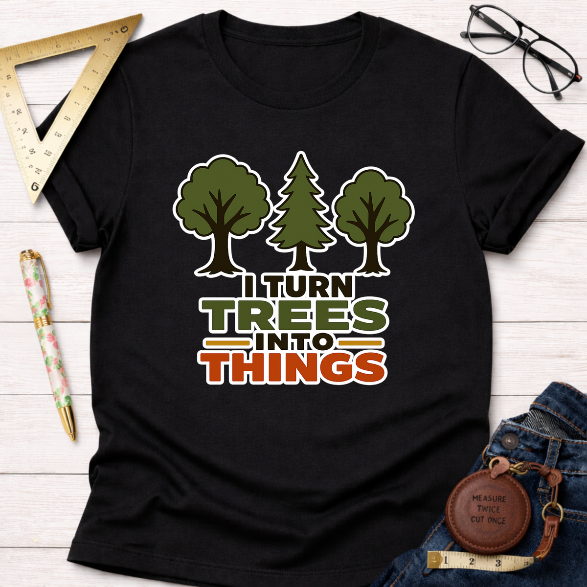 Black cotton t-shirt with "I Turn Trees Into Things" graphic and tree illustrations.