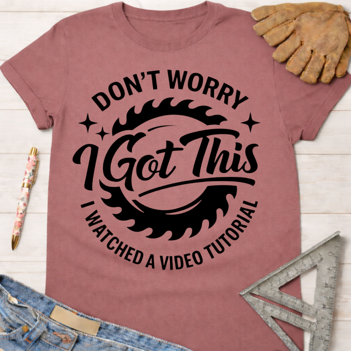Women's funny woodworking graphic tee shirt for female woodworkers, makers, and DIY builders — Sawdust & Ponytails. Mauve t-shirt with "Don't Worry I Got This I Watched a Video Tutorial" text and saw blade graphic.
