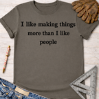 Women's funny woodworking graphic tee shirt for female woodworkers, makers, and DIY builders — Sawdust & Ponytails. Dark gray cotton t-shirt with "I like making things more than I like people" text.