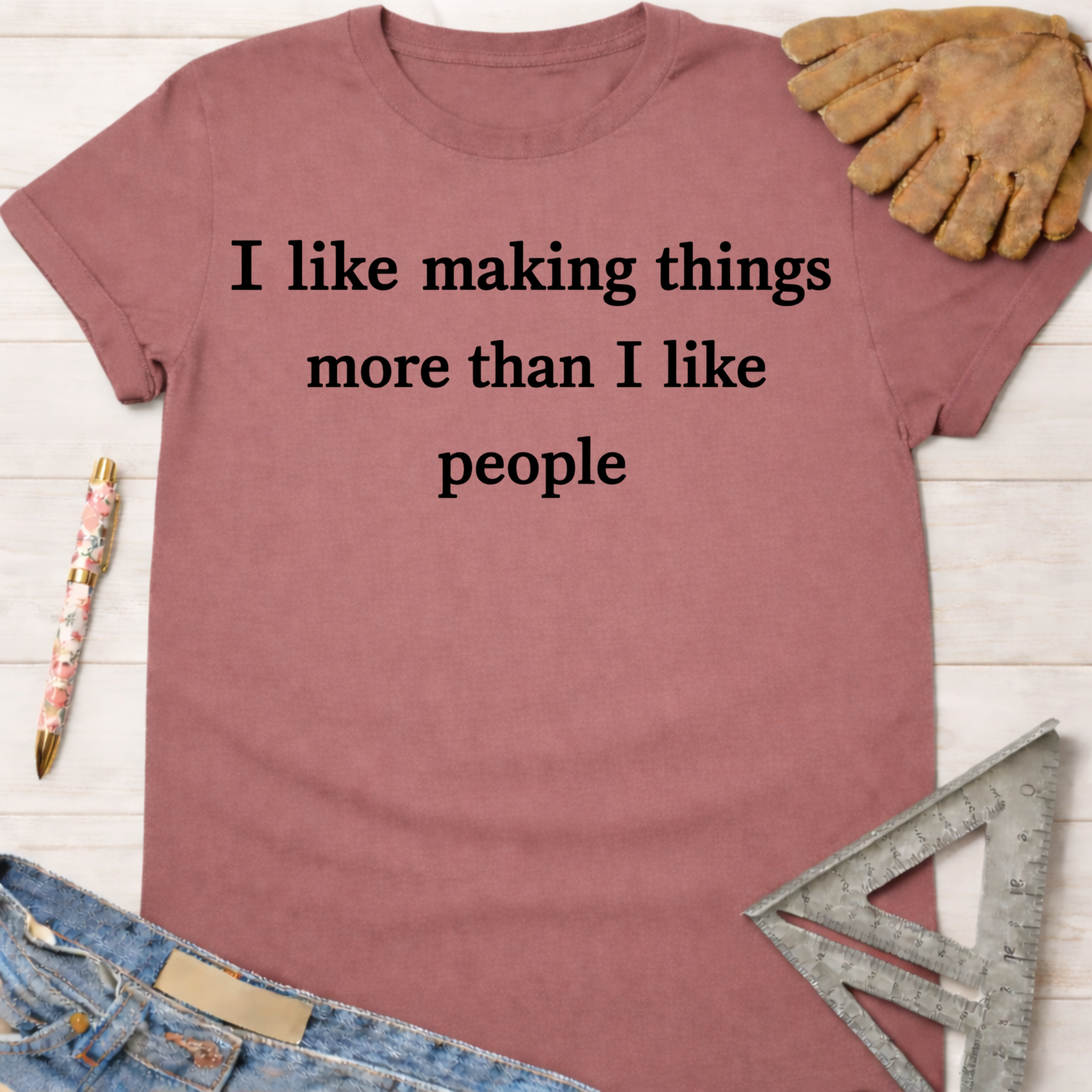 Women's funny woodworking graphic tee shirt for female woodworkers, makers, and DIY builders — Sawdust & Ponytails. Mauve cotton t-shirt with "I like making things more than I like people" text.