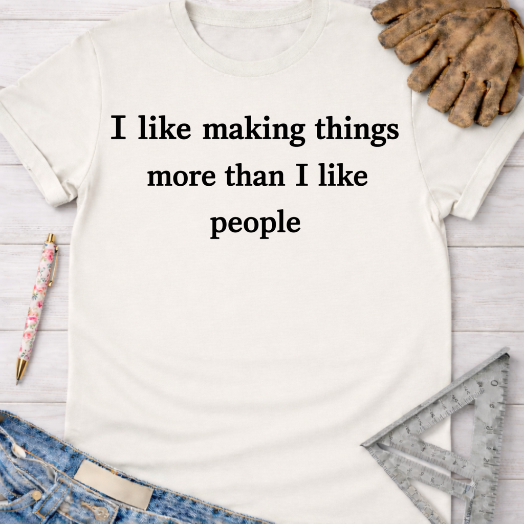 Women's funny woodworking graphic tee shirt for female woodworkers, makers, and DIY builders — Sawdust & Ponytails. White cotton t-shirt with "I like making things more than I like people" text.