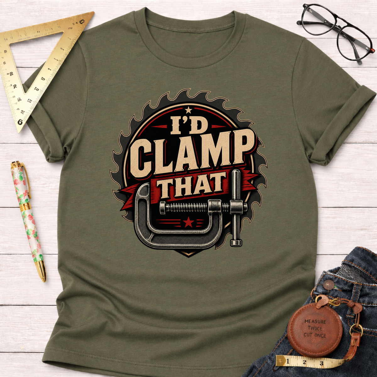 Olive green "I'd Clamp That" t-shirt with a graphic of a C-clamp and saw blade design.