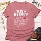 Pink "I'll Be In My Office" t-shirt with a white graphic of a saw table, tools, and a red coffee mug.