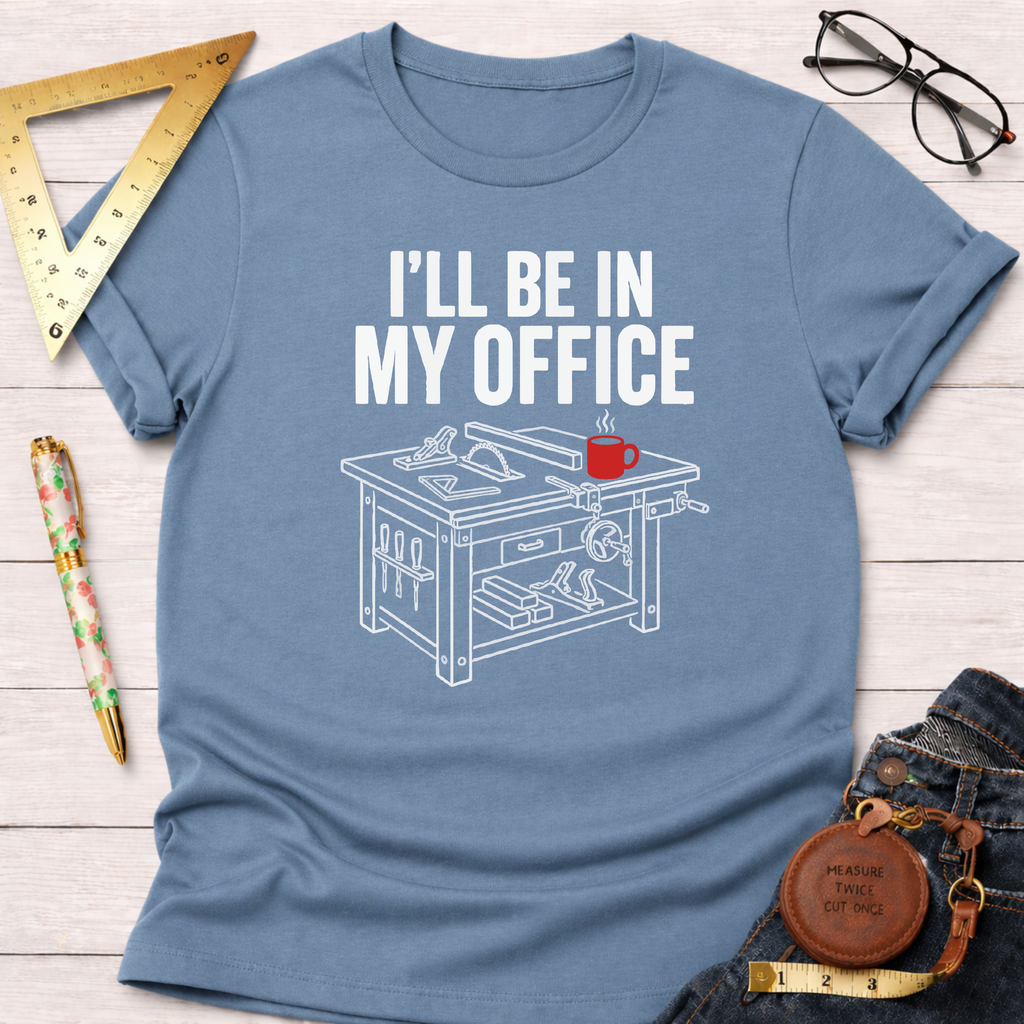 Light blue cotton t-shirt with "I'LL BE IN MY OFFICE" text and a white workbench graphic with a red coffee mug.