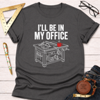Dark gray cotton t-shirt with "I'LL BE IN MY OFFICE" text and a white line art saw table design with a red coffee mug.