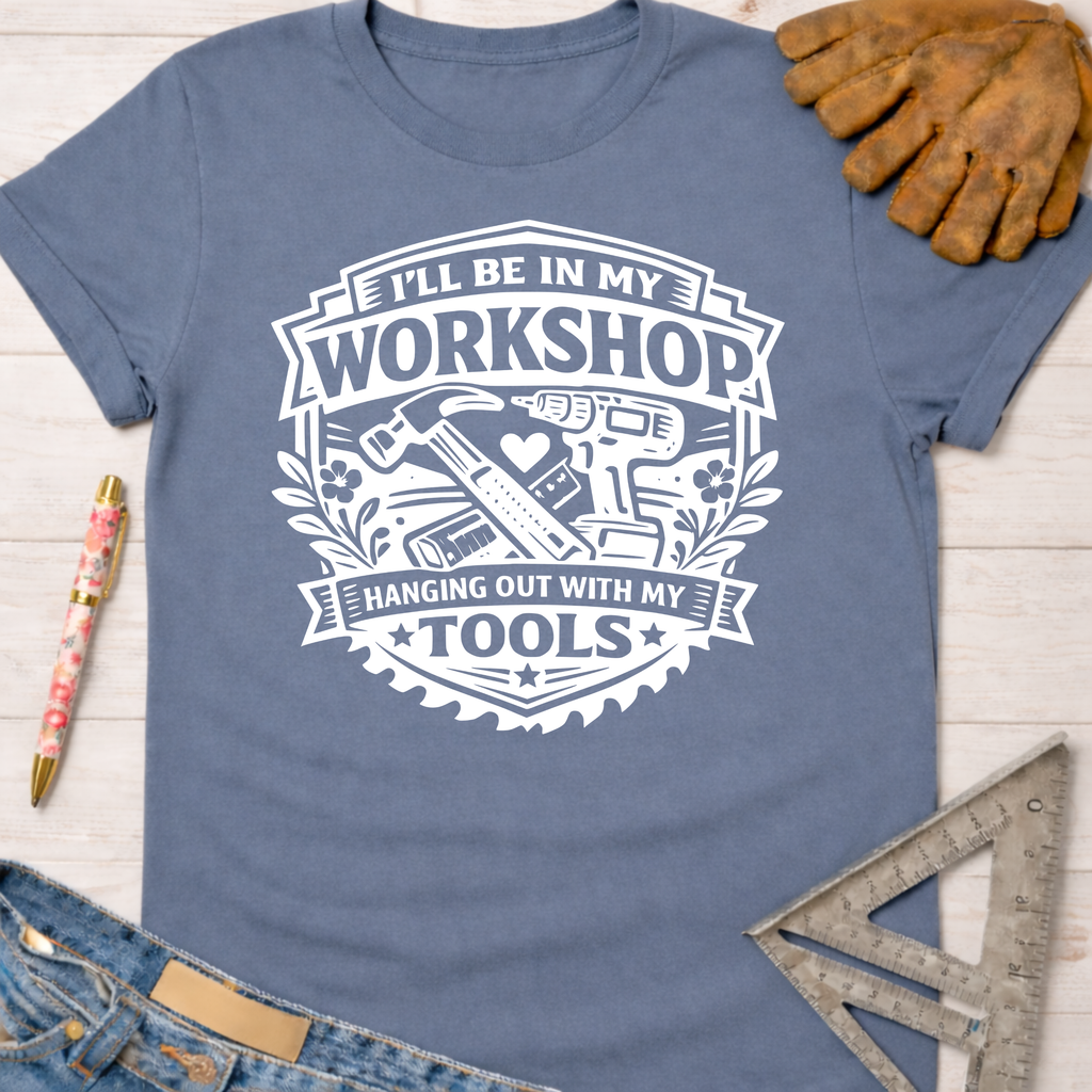 Women's funny woodworking graphic tee shirt for female woodworkers, makers, and DIY builders — Sawdust & Ponytails. Blue cotton tee with "I'll Be In My Workshop Hanging Out With My Tools" graphic.