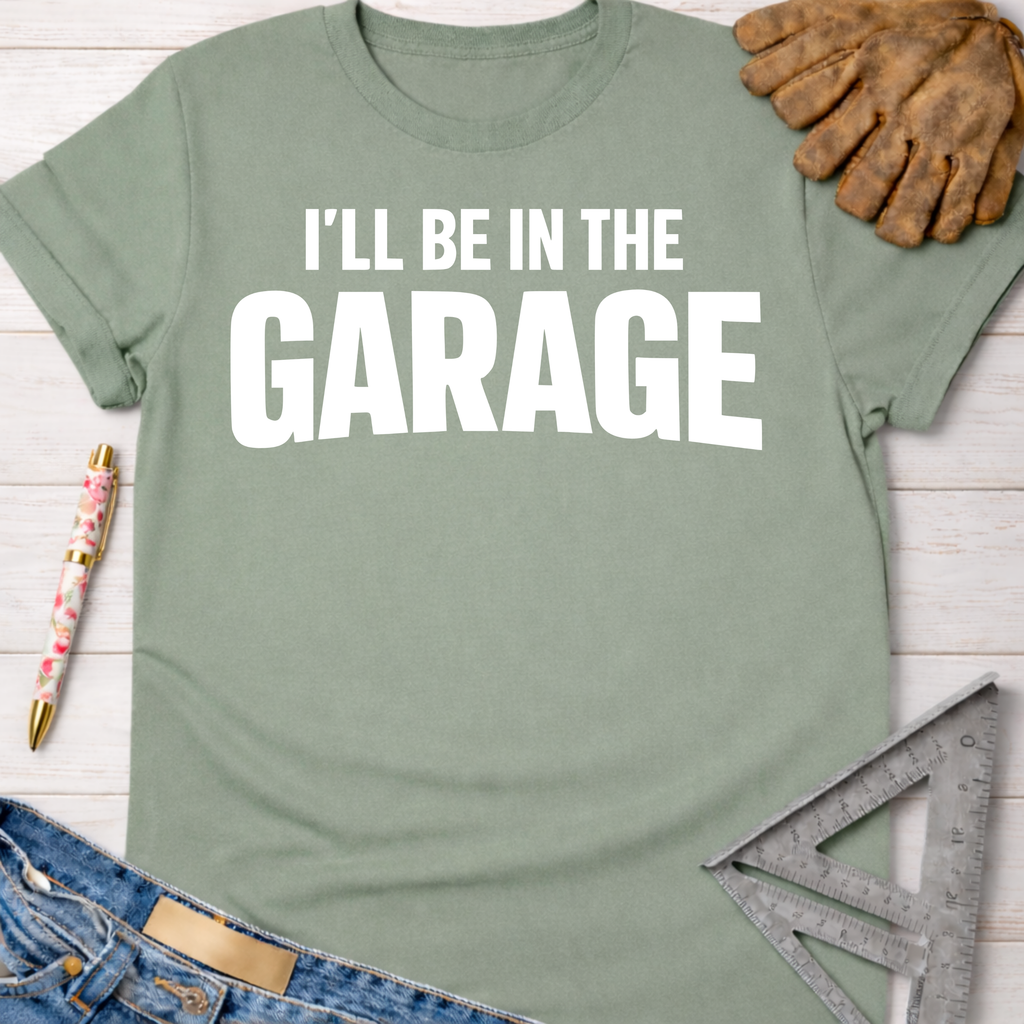 Sage green "I'll Be In The Garage" graphic tee, women's funny woodworking shirt for makers & DIY builders — Sawdust & Ponytails.