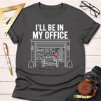 Charcoal gray t-shirt with "I'LL BE IN MY OFFICE" and a detailed garage workshop graphic.
