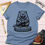 Women's funny woodworking graphic tee shirt for female woodworkers, makers, and DIY builders — Sawdust & Ponytails. Light blue cotton tee with a black beaver holding wood and "I'M GOOD WITH WOOD" graphic.
