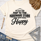 Women's funny woodworking graphic tee shirt for female woodworkers, makers, and DIY builders — Sawdust & Ponytails. Cream t-shirt with "I'm Just One Trip To The Hardware Store Away From Being Happy" in black text.