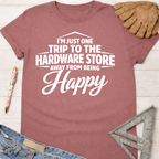 Women's funny woodworking graphic tee shirt for female woodworkers, makers, and DIY builders — Sawdust & Ponytails. Mauve short-sleeve tee with "I'm Just One Trip To The Hardware Store Away From Being Happy" in white text.