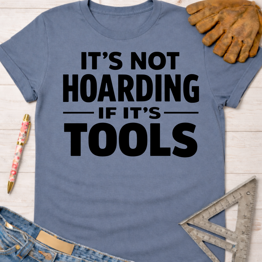 Women's funny woodworking graphic tee shirt for female woodworkers, makers, and DIY builders — Sawdust & Ponytails. Blue cotton tee with "IT'S NOT HOARDING IF IT'S TOOLS" in black text.