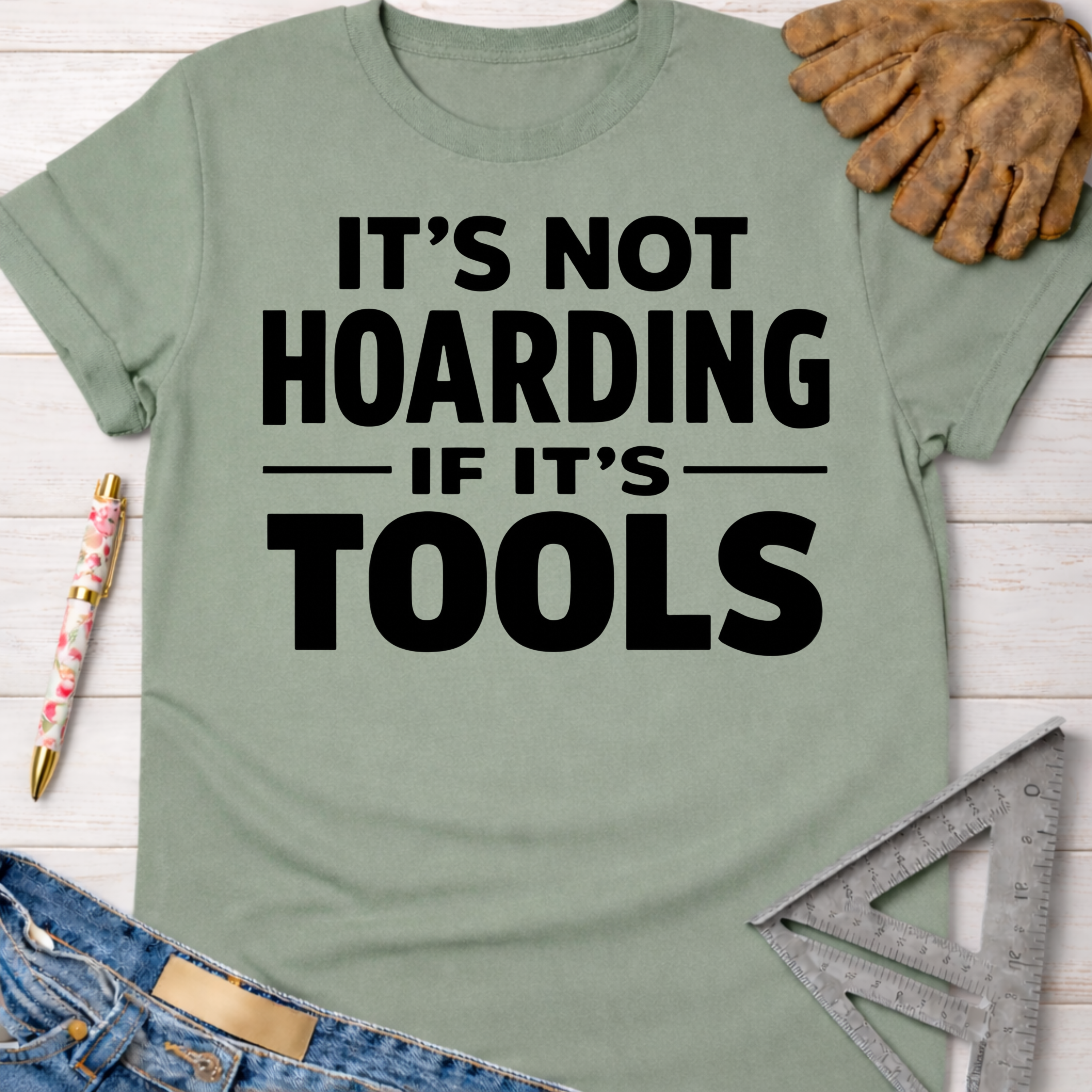 Women's funny woodworking graphic tee shirt for female woodworkers, makers, and DIY builders — Sawdust & Ponytails. Sage green cotton tee with "It's Not Hoarding If It's Tools" in black text.