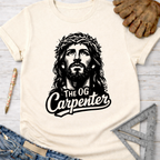 Women's funny woodworking graphic tee shirt for female woodworkers, makers, and DIY builders — Sawdust & Ponytails. Cream t-shirt with black "Jesus The OG Carpenter" graphic.