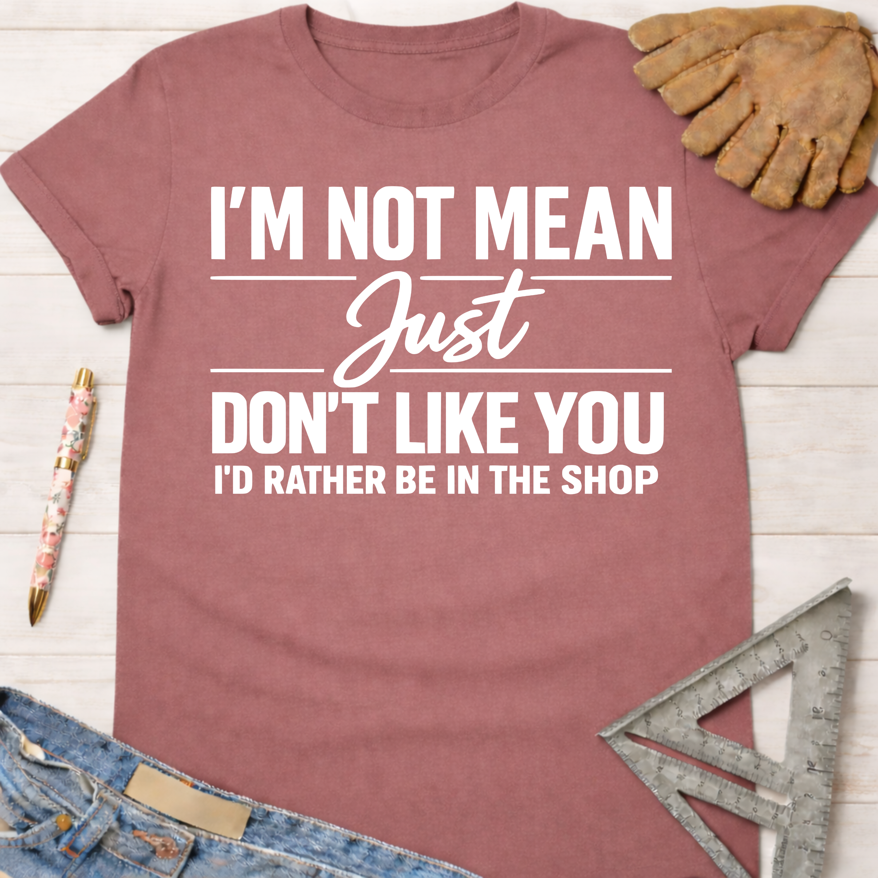 Women's funny woodworking graphic tee shirt for female woodworkers, makers, and DIY builders — Sawdust & Ponytails. Mauve cotton tee with "I'm Not Mean Just Don't Like You I'd Rather Be In The Shop" in white text.