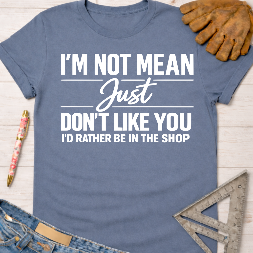 Women's funny woodworking graphic tee shirt for female woodworkers, makers, and DIY builders — Sawdust & Ponytails. Blue cotton tee with "I'm Not Mean Just Don't Like You I'd Rather Be In The Shop" text.