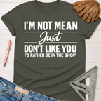 Women's funny woodworking graphic tee shirt for female woodworkers, makers, and DIY builders — Sawdust & Ponytails. Dark gray crew neck tee with white "I'm Not Mean Just Don't Like You I'd Rather Be In The Shop" text.