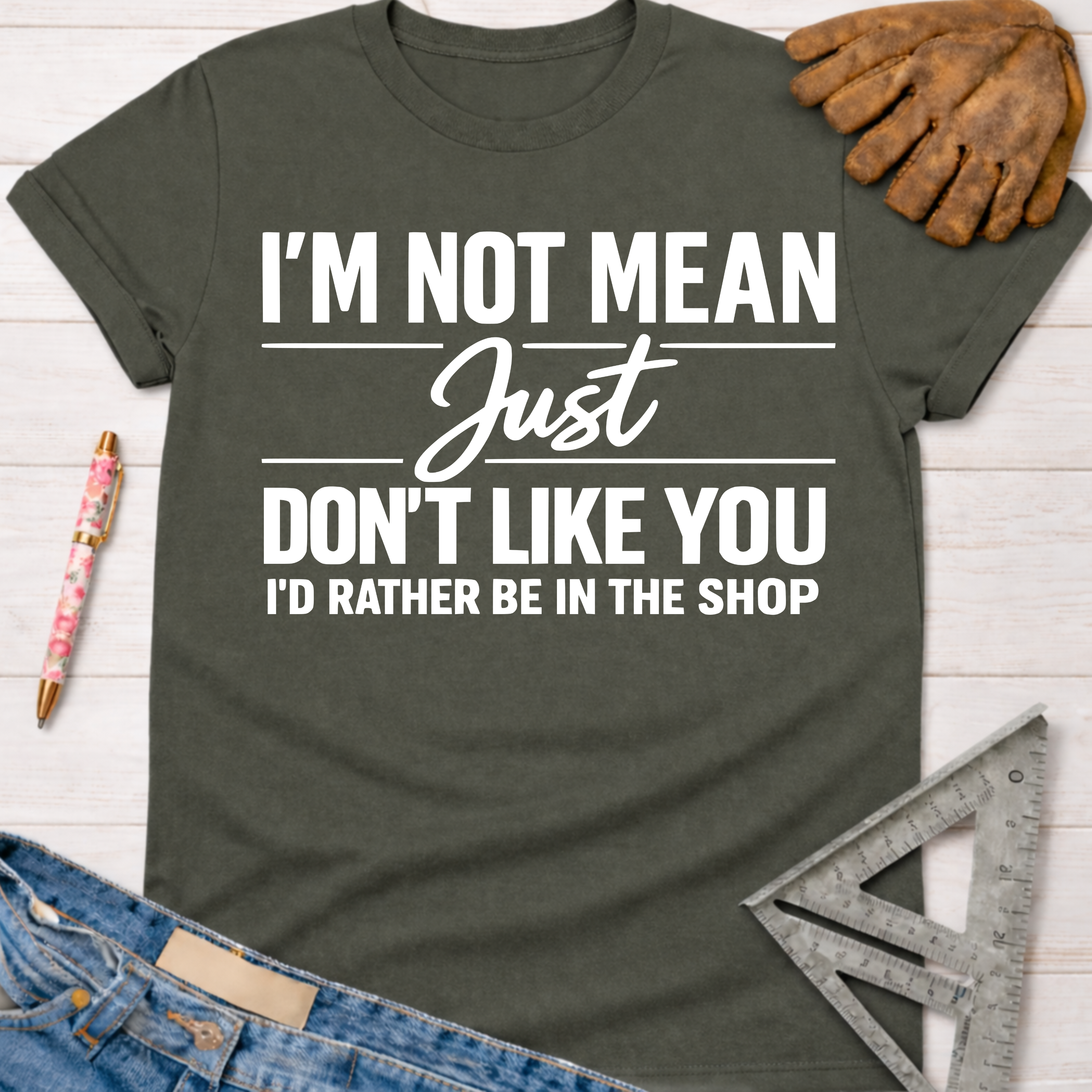 Women's funny woodworking graphic tee shirt for female woodworkers, makers, and DIY builders — Sawdust & Ponytails. Dark gray crew neck tee with white "I'm Not Mean Just Don't Like You I'd Rather Be In The Shop" text.