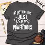 Charcoal gray t-shirt with "No Instructions Just Vibes And Power Tools" in white text.