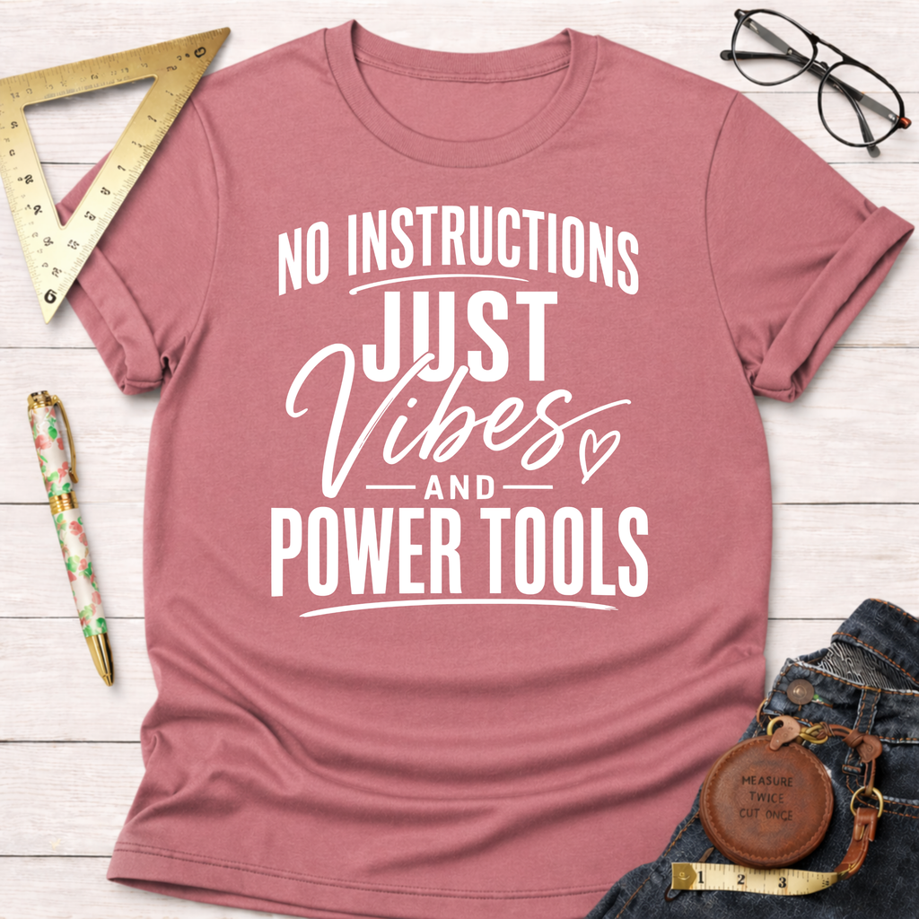 Mauve pink t-shirt with "NO INSTRUCTIONS JUST Vibes AND POWER TOOLS" in white text.