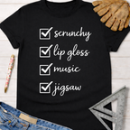 Black cotton women's funny woodworking graphic tee shirt with "scrunchy, lip gloss, music, jigsaw" checklist. Sawdust & Ponytails.