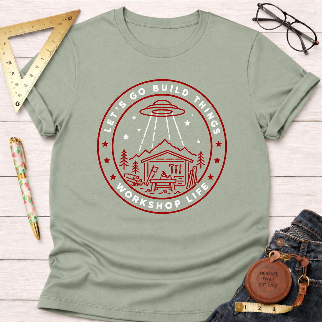 Sage green "Let's Go Build Things Workshop Life" t-shirt with a red graphic of a UFO abducting a workshop.