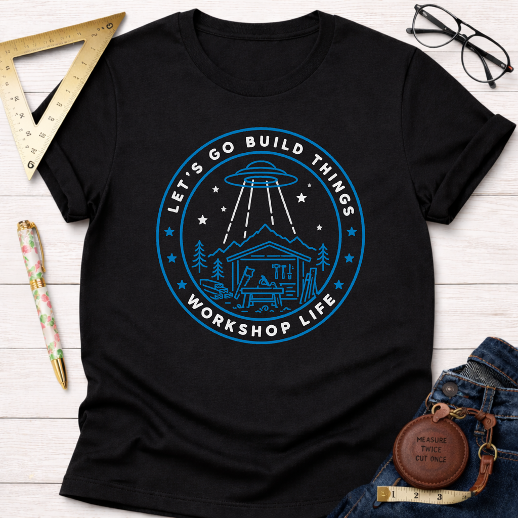 Black cotton t-shirt with a blue "Let's Go Build Things Workshop Life" graphic featuring a UFO and workshop.