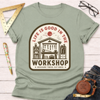 Women's funny woodworking graphic tee shirt for female woodworkers, makers, and DIY builders — Sawdust & Ponytails. Light green cotton tee with "Life Is Good In The Workshop" graphic.