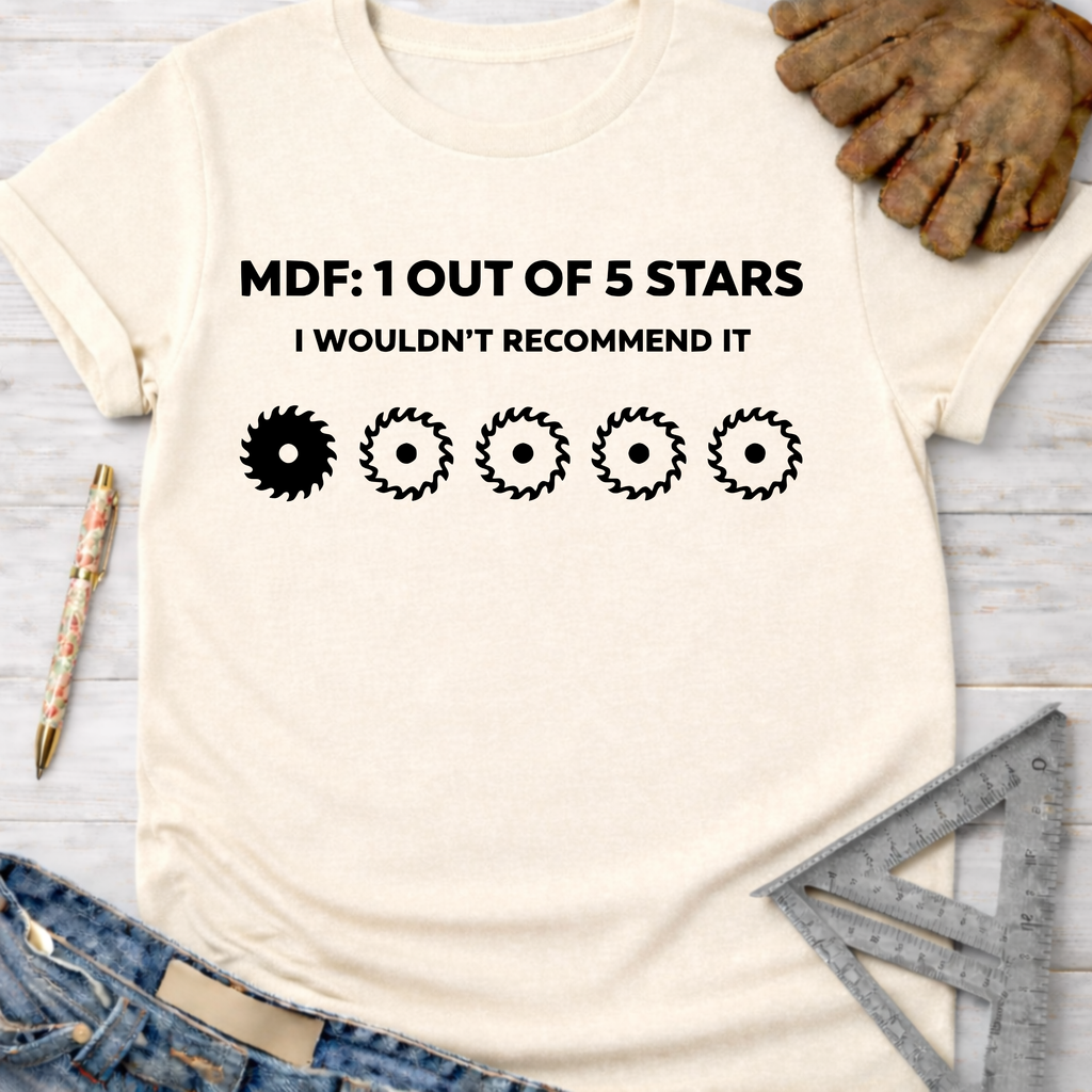 Women's funny woodworking graphic tee shirt for female woodworkers, makers, and DIY builders — Sawdust & Ponytails. Cream t-shirt with "MDF: 1 OUT OF 5 STARS I WOULDN'T RECOMMEND IT" and saw blade rating.