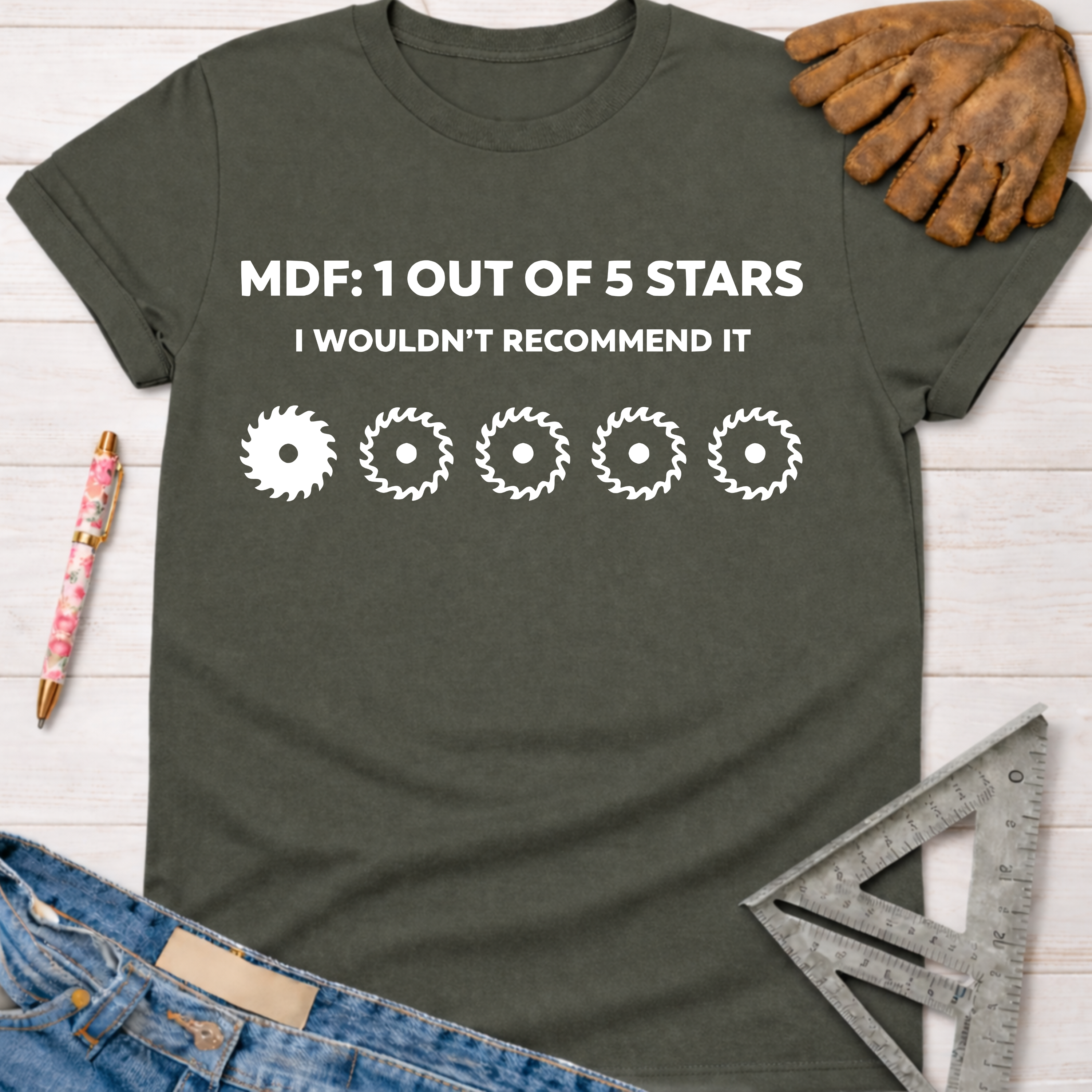 Women's funny woodworking graphic tee shirt for female woodworkers, makers, and DIY builders — Sawdust & Ponytails. Dark gray t-shirt with "MDF: 1 Out Of 5 Stars I Wouldn't Recommend It" and saw blade graphics.