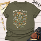 Olive green cotton t-shirt with "Made To Make" text and a colorful, ornate paintbrush design.