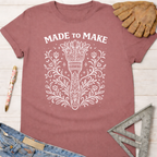 Women's funny woodworking graphic tee shirt for female woodworkers, makers, and DIY builders — Sawdust & Ponytails. Mauve short-sleeve tee with "MADE TO MAKE" and floral tool design.