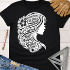 Women's funny woodworking graphic tee shirt for female woodworkers, makers, and DIY builders — Sawdust & Ponytails. Black cotton tee with white silhouette of a woman's head, her hair filled with tools and text like "Measure Twice Cut Once" and "Built Not Bought.