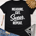 Black cotton tee with "MEASURE. CUT. Swear. REPEAT." in white. Women's funny woodworking graphic tee shirt for female woodworkers, makers, and DIY builders — Sawdust & Ponytails.
