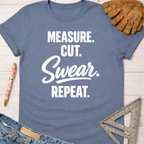 Blue cotton tee with "MEASURE. CUT. Swear. REPEAT." text. Women's funny woodworking graphic tee shirt for female woodworkers, makers, and DIY builders — Sawdust & Ponytails