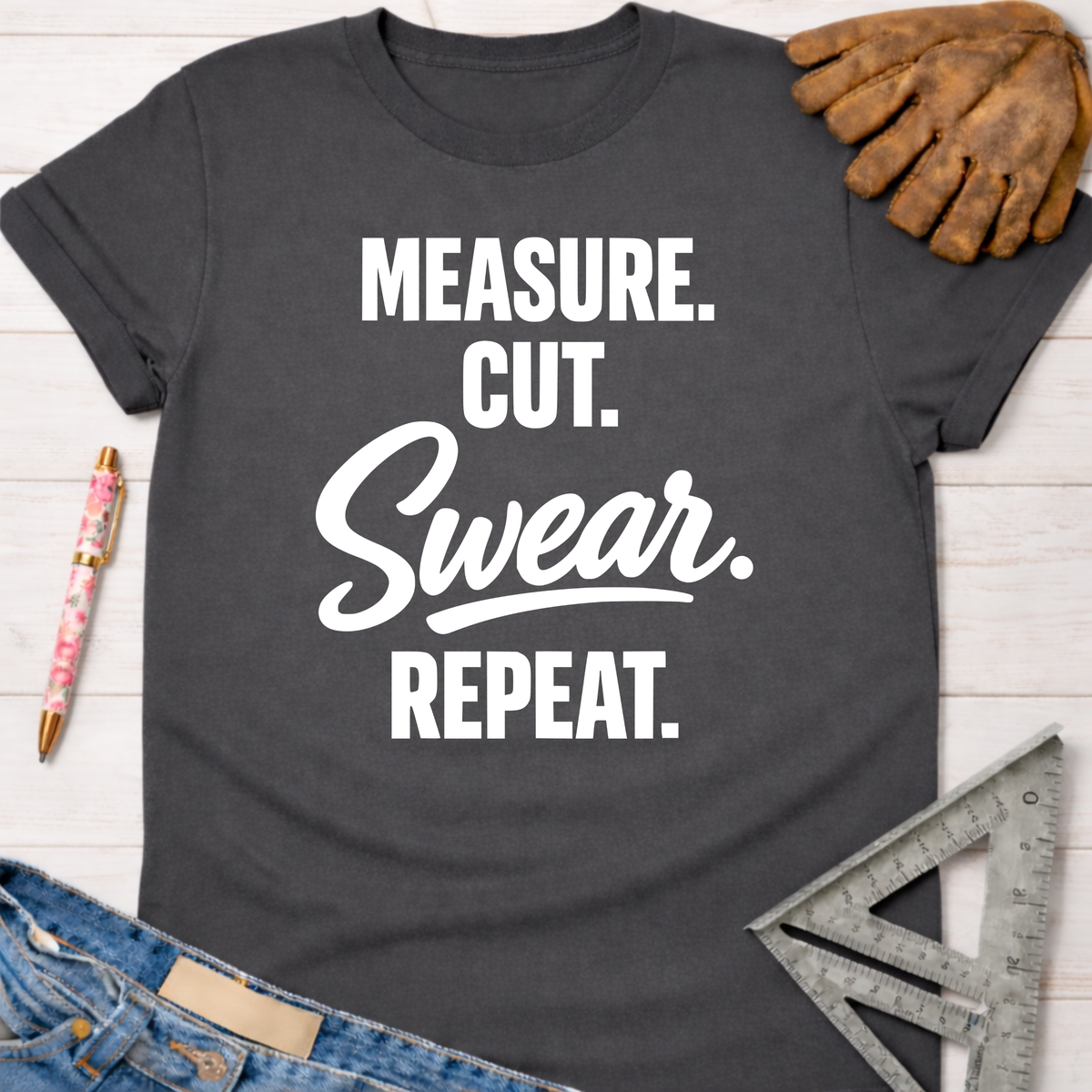 Charcoal gray women's "Measure. Cut. Swear. Repeat." graphic tee for female woodworkers, makers, and DIY builders — Sawdust & Ponytails