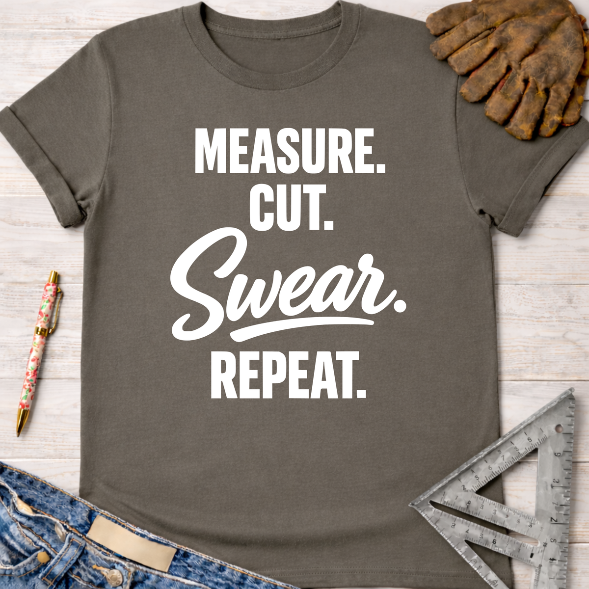 Charcoal gray women's "Measure. Cut. Swear. Repeat." tee, Sawdust & Ponytails, for female woodworkers.