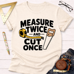 Cream t-shirt with "Measure Twice And Cut Once" graphic, featuring a tape measure and hand saw.