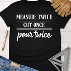 Women's funny woodworking graphic tee shirt for female woodworkers, makers, and DIY builders — Sawdust & Ponytails. Black cotton tee with "MEASURE TWICE CUT ONCE pour twice" in white text.