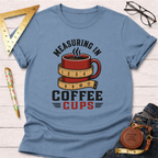 Blue t-shirt with "Measuring In Coffee Cups" text and a red coffee mug wrapped in a measuring tape design.