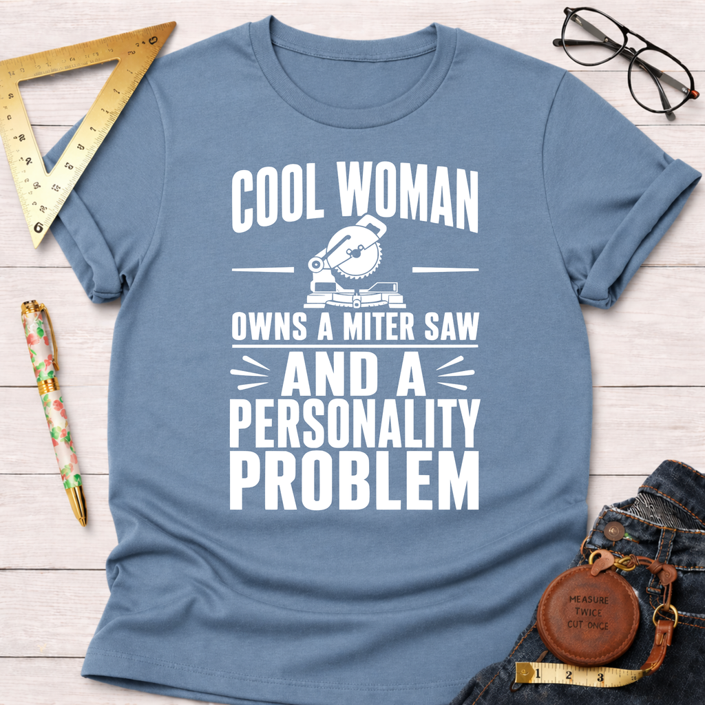 Light blue cotton t-shirt with "Cool Woman Owns A Miter Saw And A Personality Problem" graphic.