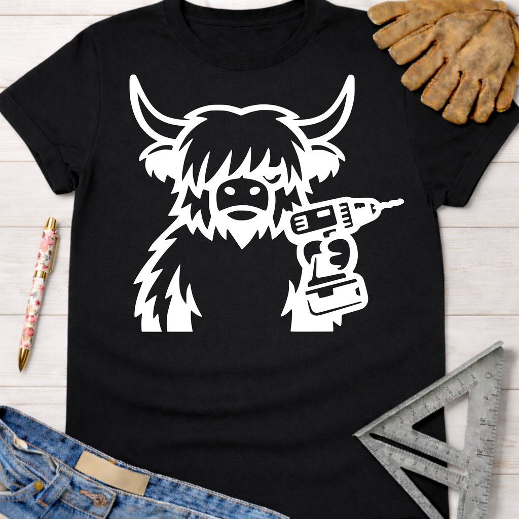 Black women's funny woodworking graphic tee with white Highland cow holding a drill. Sawdust & Ponytails.