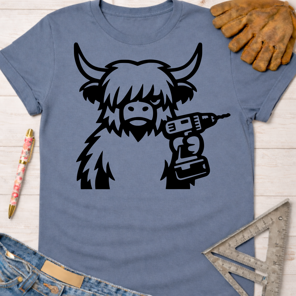 Women's funny woodworking graphic tee shirt for female woodworkers, makers, and DIY builders — Sawdust & Ponytails. Blue cotton t-shirt with a black Highland cow holding a drill.