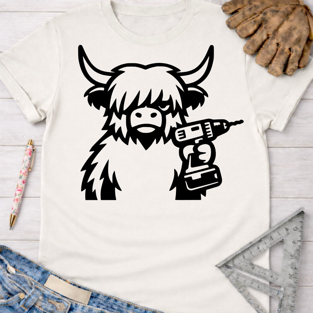 Women's funny woodworking graphic tee shirt for female woodworkers, makers, and DIY builders — Sawdust & Ponytails. White cotton t-shirt with a black cartoon Highland cow holding a drill.